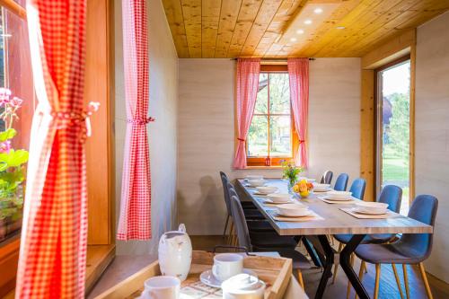 a dining room with a long table and chairs at Holiday Raj in Bešeňová