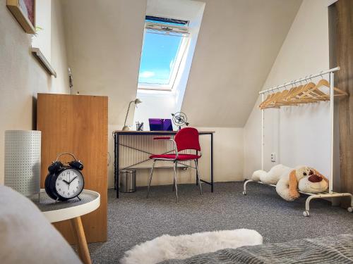 a bedroom with a bed and a desk and a chair at Ping pong Cottage in heart of Liptov in Jakubovany