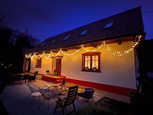 a house with lights on the side of it at night at Ping pong Cottage in heart of Liptov in Jakubovany