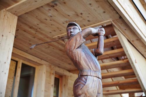 a statue of a baseball player swinging a bat at SportLodge GOLF SUITE - Cozy Apartment with Shared Pool, Whirlpool & Sauna, presented by AlpenLuxus in Kleinboden