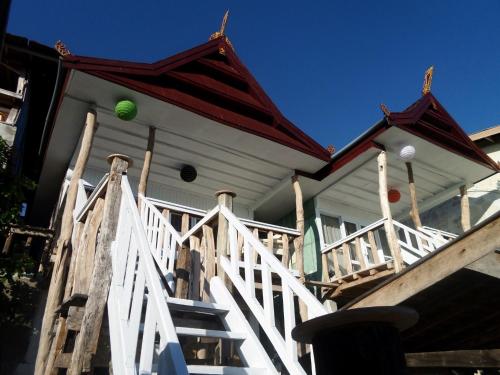 a house with a green ball on the top of the stairs at Amatoa Resort in Bira