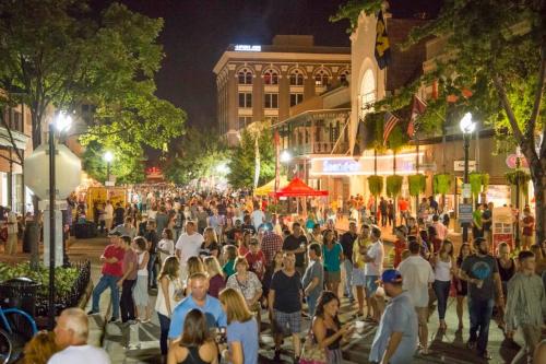 a crowd of people walking down a street at night at Beautiful Historic Downtown Pensacola Charmer - Hot Tub in Pensacola