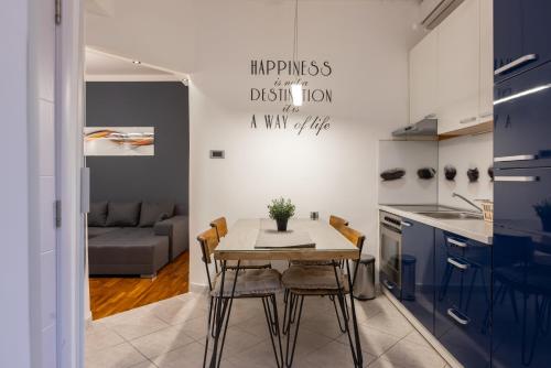 a kitchen and dining room with a table and chairs at Central Park Apartments in Belgrade