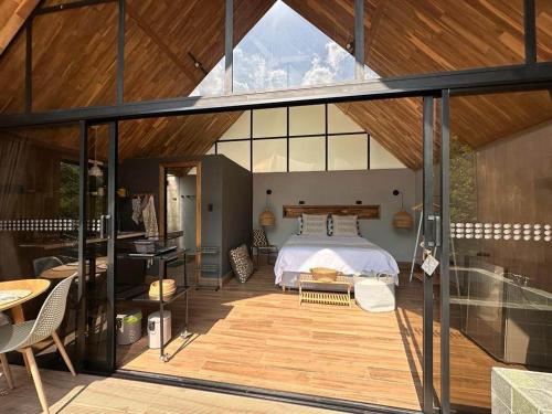 a bedroom in a house with a bed on a deck at Ceiba del Agua in San Rafael