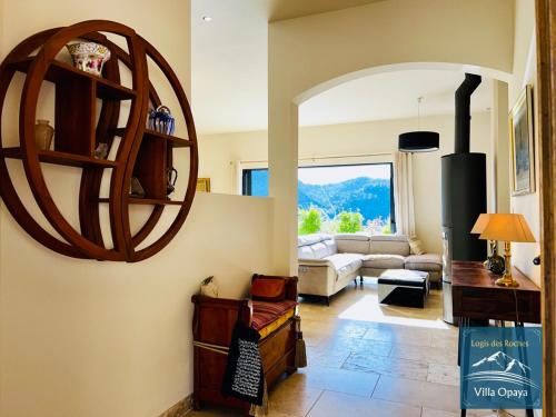 a living room with a large mirror on the wall at LOGIS DES ROCHES - 2 VILLAS VUE EXCEPTIONNELLE - Le Petit Chevalet, Le Grand Sabouillon in Buis-les-Baronnies