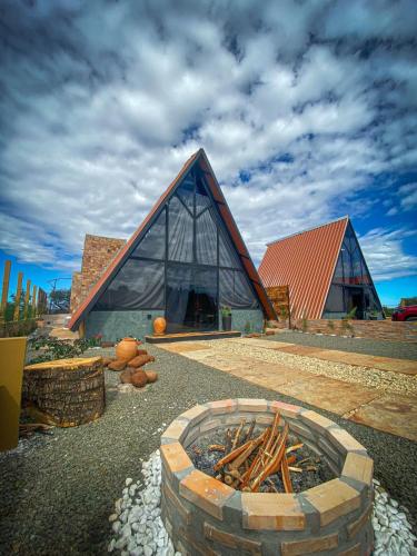 a large building with a fire pit in front of it at Canrobert Village in Pedro II