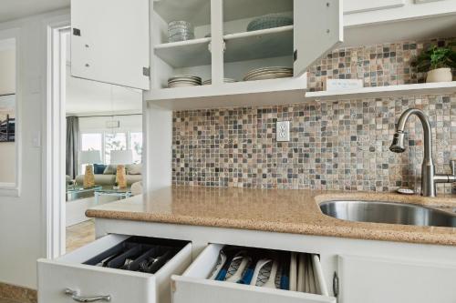 a kitchen with a sink and a counter at Sunrise at the Beach - 2BR Apt with Scenic Views in Satellite Beach