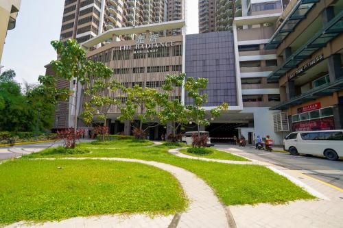 a park in the middle of a street with buildings at The Radiance Manila Bay Studio in Manila