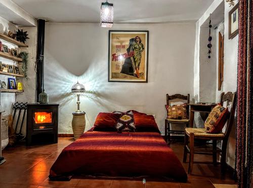 a bedroom with a bed and a fire place at Lemon Tree Patio in Olvera