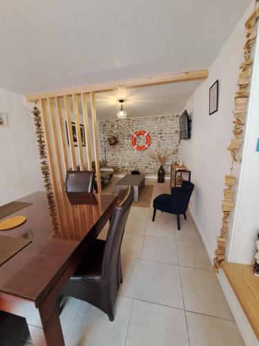 a dining room and living room with a table and chairs at Granville plage normandie mont saint Michel in Granville