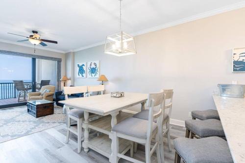 a dining room with a table and chairs at Grand Pointe Unit 506 in Orange Beach
