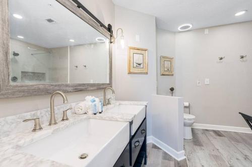 a white bathroom with a sink and a toilet at Grand Pointe Unit 506 in Orange Beach