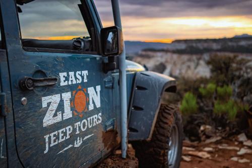 a blue truck with the words east 20nm speed tours on the door at Zion Ponderosa Ranch Resort in Springdale