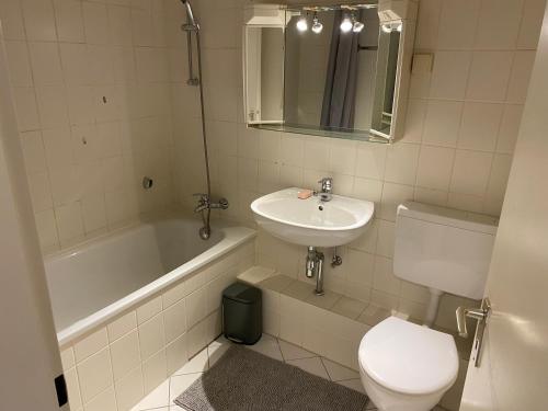 een badkamer met een wastafel, een toilet en een bad bij Laatzen Messe nähe in Hannover