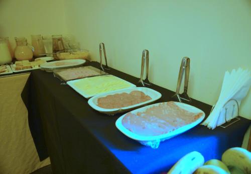 a table with three trays of food on it at Hosteria Patagon in Villa La Angostura