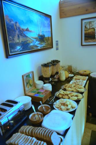 a table with a buffet with food on it at Hosteria Patagon in Villa La Angostura
