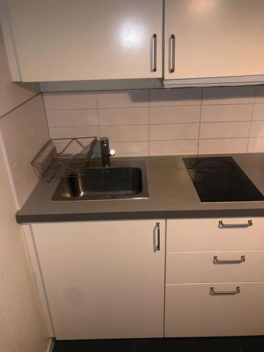 a kitchen with a sink and a counter top at Kulladal 1 in Malmö