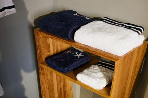 a wooden shelf with blue and white towels on it at Private Studio Loft w. Bosphorus view near Galata in Istanbul