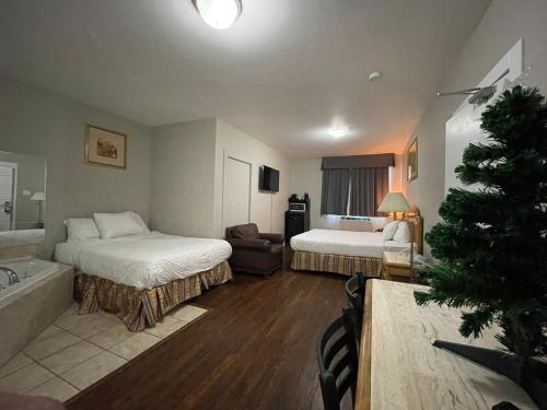 a hotel room with two beds and a christmas tree at Travelodge by Wyndham London Ontario in London