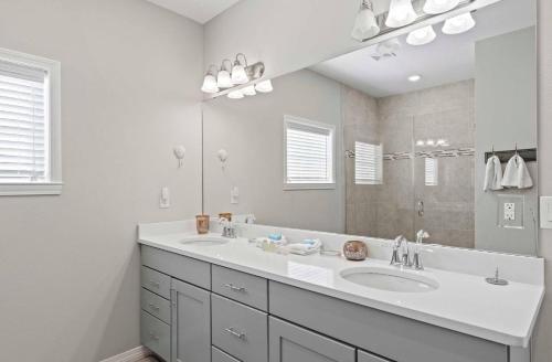 a bathroom with two sinks and a large mirror at Paradise Key at Lost Key Golf & Beach Club in Pensacola