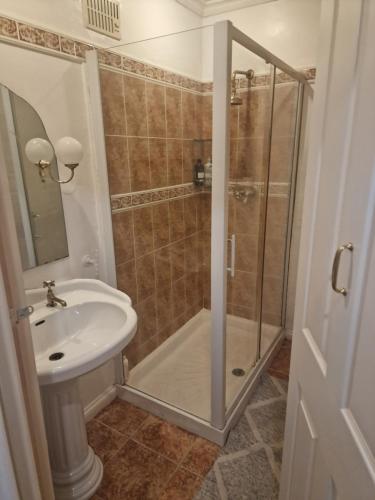a bathroom with a shower and a sink at 51 Nonsuch Walk, Cheam in Cheam