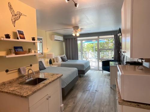 a kitchen and a living room with a bed in a room at The Frederiksted Hotel in Frederiksted