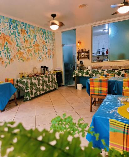 a restaurant with two tables and blue clothed tables at Pousada Aquarela do Mar in Abraão