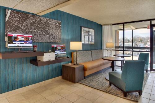 a hotel room with a couch and a tv at Pear Tree Inn St. Louis Airport in Edmundson