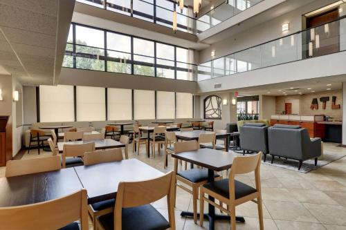 a dining room with tables and chairs and windows at Drury Inn & Suites Atlanta Marietta in Marietta