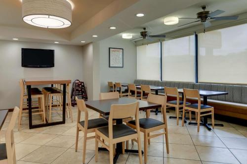 a dining room with tables and chairs and a screen at Drury Inn & Suites Atlanta Marietta in Marietta
