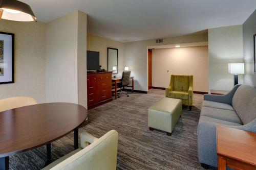 a living room with a couch and a table at Drury Inn & Suites Atlanta Marietta in Marietta