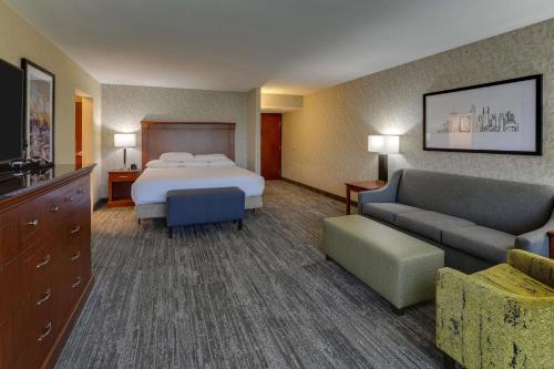 a hotel room with a bed and a couch at Drury Inn & Suites Atlanta Marietta in Marietta