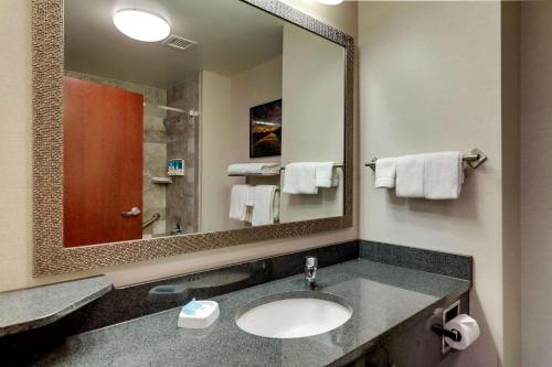 a bathroom with a sink and a large mirror at Drury Inn & Suites St. Louis Arnold in Arnold