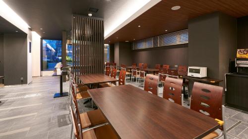 a dining room with tables and chairs in a building at The Celecton Kyoto Horikawa Sanjo in Kyoto