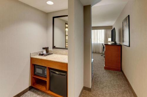 a hotel room with a sink and a mirror at Drury Inn & Suites Phoenix Airport in Phoenix