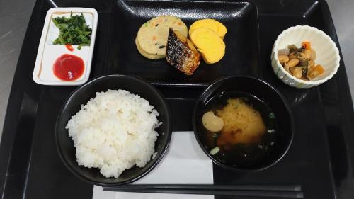 a black tray with rice and different types of food at The Celecton Kyoto Horikawa Sanjo in Kyoto