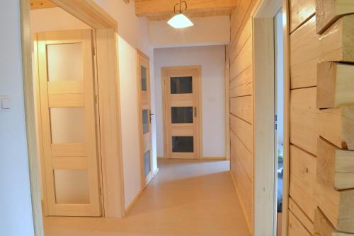 a hallway of a house with wooden doors at Dom w Szkotowie in Januszkowo