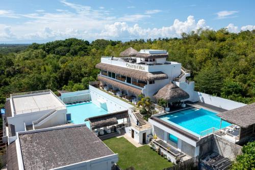 an aerial view of a mansion with a swimming pool at Bohol Coastal View Hotel in Tawala