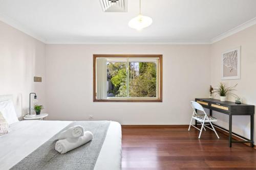 a bedroom with a bed with a desk and a window at Queen Room in Gordon near Train & Bus Sleep 2 in Pymble