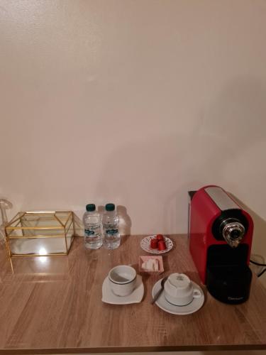 a table with a toaster and two plates and water bottles at Hôtel et Restaurant ARIJ in Midelt