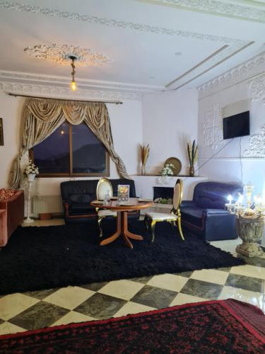 a living room with a couch and a table at Hôtel et Restaurant ARIJ in Midelt