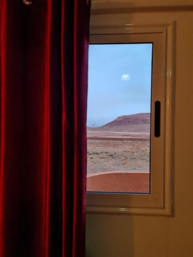a window in a room with a view of the desert at Hôtel et Restaurant ARIJ in Midelt