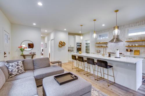 a living room with a couch and a kitchen at Modern Kirkland Home with Private Yard and Fire Pit! in Kirkland