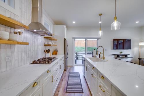 a kitchen with white counters and a stove top oven at Modern Kirkland Home with Private Yard and Fire Pit! in Kirkland