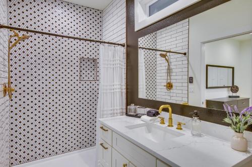 a bathroom with a tub and a sink and a mirror at Modern Kirkland Home with Private Yard and Fire Pit! in Kirkland