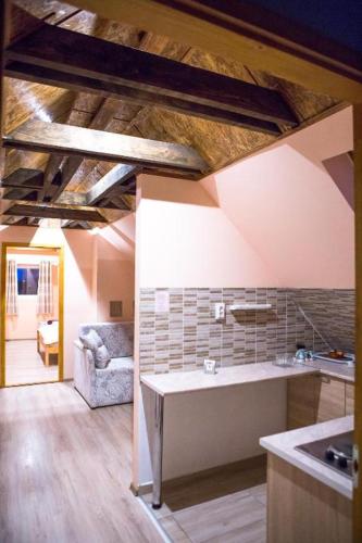 a kitchen with a table and a couch in a room at Csongor Vendégház in Bogács