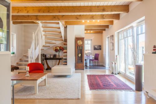a living room with a staircase and a table at Lieblingsplatz in Maasholm