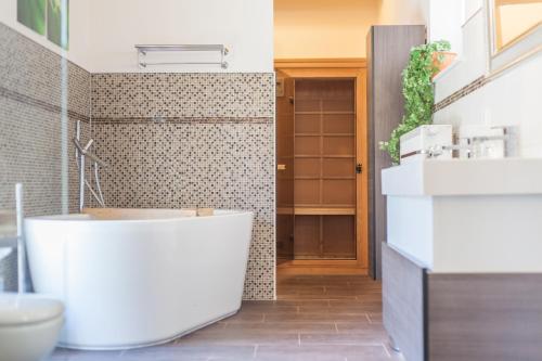 a bathroom with a white tub and a sink at Lieblingsplatz in Maasholm