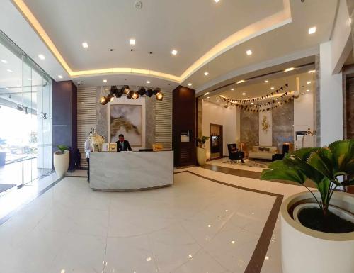 a lobby with a reception desk in a building at 2 BR condo at One Regis - Megaworld in Bacolod