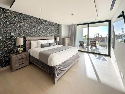 a bedroom with a large bed and a balcony at Brand New 3BR Ground Floor Pool Walkout at Las Palomas in Puerto Peñasco